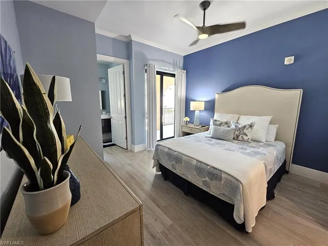 a bedroom with furniture and a flat screen tv