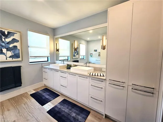 a large white room with a large window and furniture