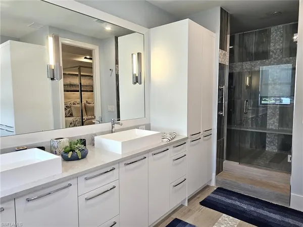 a bathroom with a granite countertop sink a toilet and shower