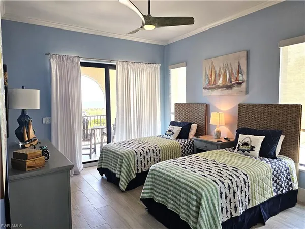 a bedroom with two beds and a large mirror