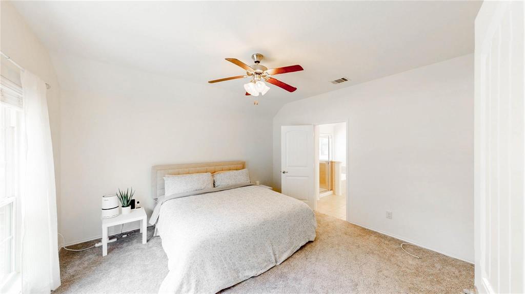 1808 Dr Sanders Road Providence Village, TX 76227 - Photo 13 of 31 a bedroom with a bed and a ceiling fan
