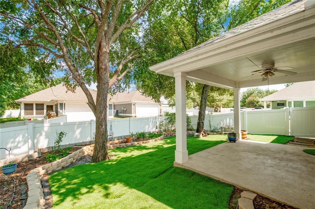 1808 Dr Sanders Road Providence Village, TX 76227 - Photo 30 of 31 a view of a house with backyard and a tree