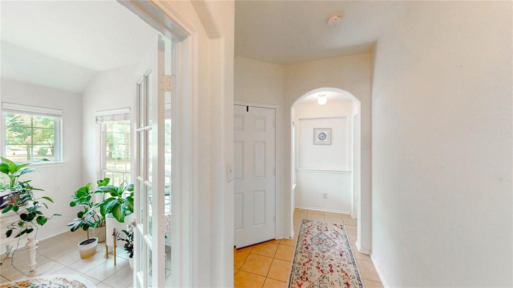 1808 Dr Sanders Road Providence Village, TX 76227 - Photo 6 of 31 a view of a hallway to filled with entryway and wooden floor