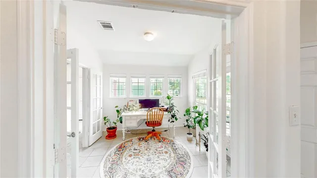 a kitchen with stainless steel appliances granite countertop a refrigerator a stove a sink a dining table and chairs with wooden floor