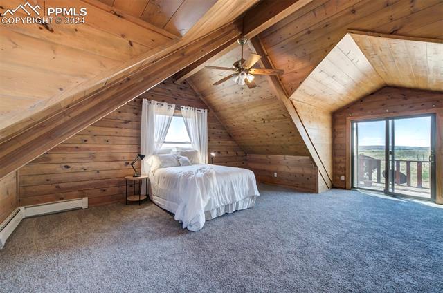 19350 Lemesany Road Calhan, CO 80808 - Photo 34 of 46 Master bedroom featuring carpet flooring, lofted ceiling with beams, and balcony