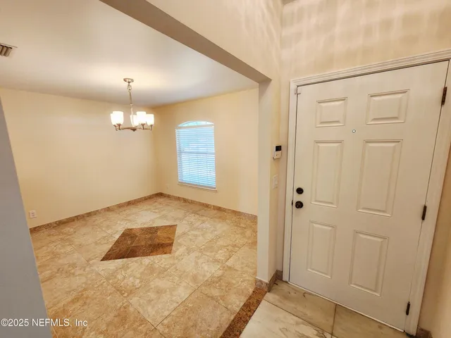 a view of a kitchen with a sink and refrigerator