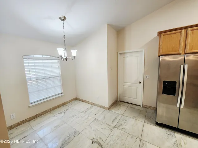 a kitchen with stainless steel appliances a refrigerator and a stove top oven