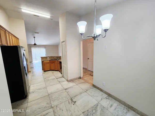 a kitchen with granite countertop a stove a sink and a refrigerator