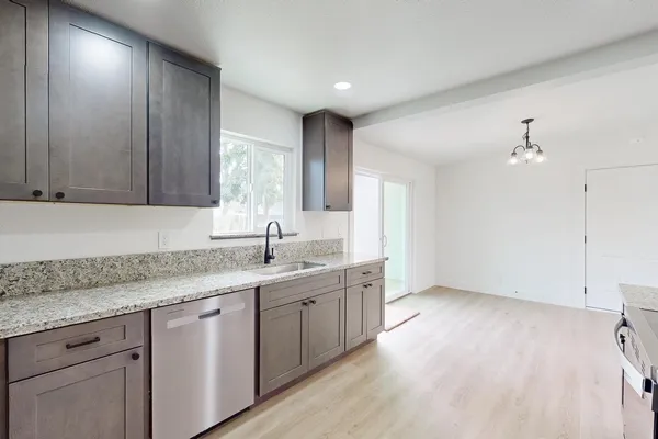 a kitchen with a sink cabinets and window