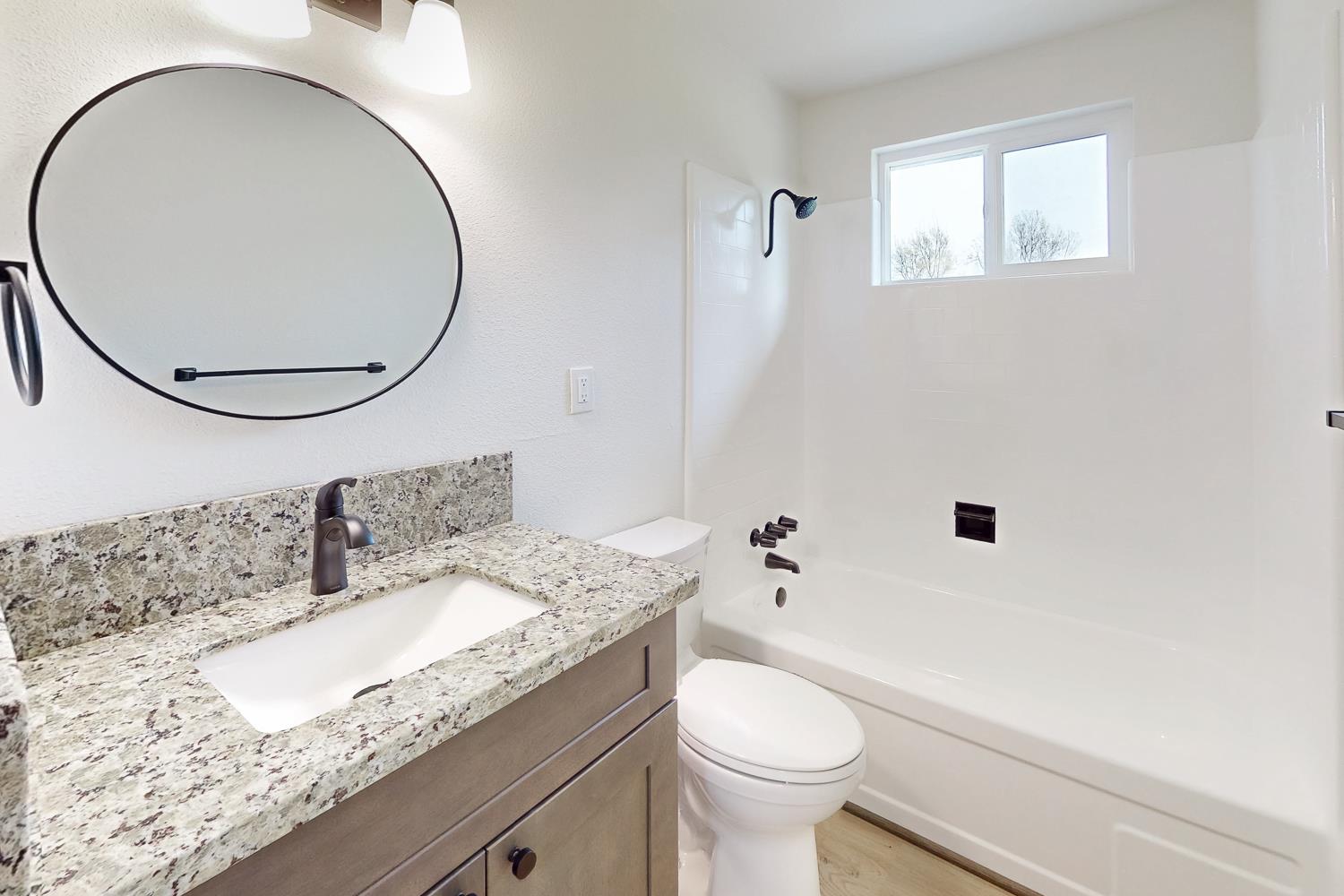 2441 Madrone Street Sutter, CA 95982 - Photo 3 of 47 a bathroom with a granite countertop sink a toilet and a mirror