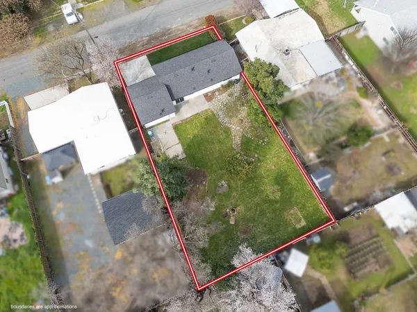 a view of house with a backyard