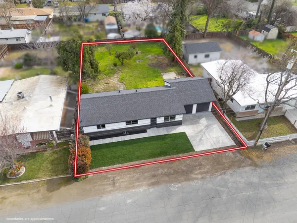 an aerial view of a house with outdoor space