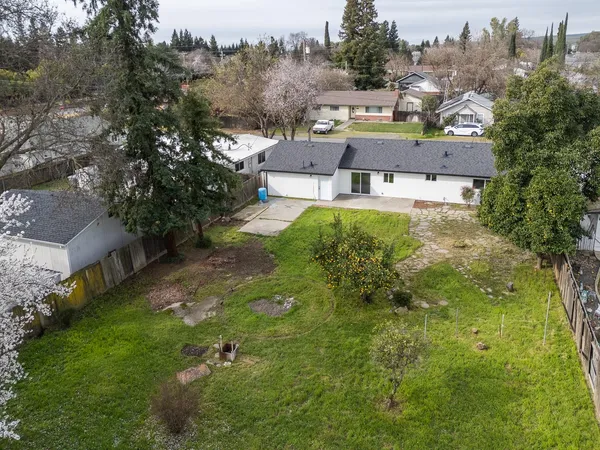 an aerial view of a house with a yard