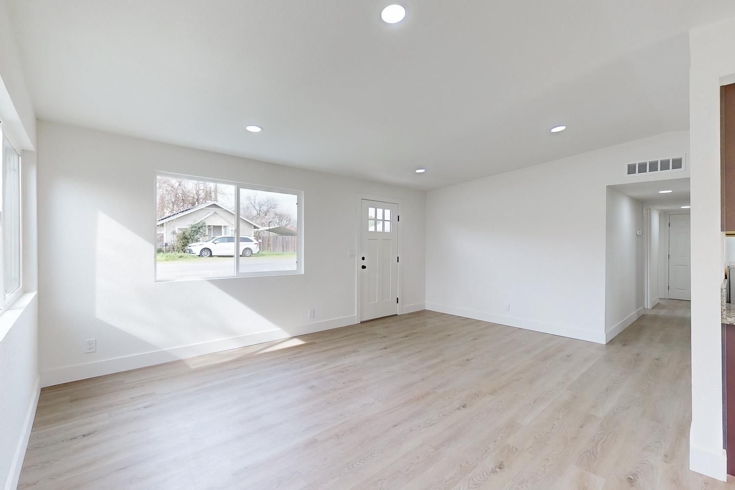 2441 Madrone Street Sutter, CA 95982 - Photo 9 of 47 an empty room with wooden floor and windows