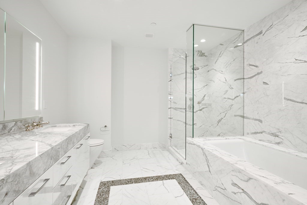 240 Devonshire Street, Unit 5801 Boston, MA 02110 - Photo 6 of 40 a spacious bathroom with a tub sink shower and a mirror