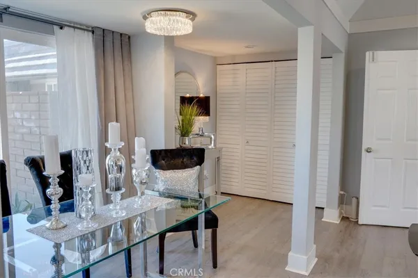 a hallway with wooden floor electronic appliances and furniture