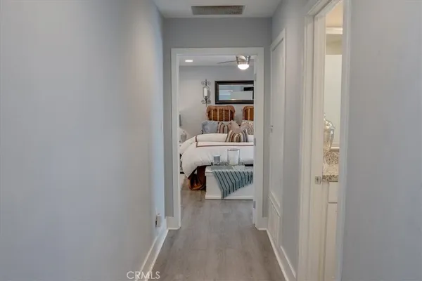 a bedroom with a bed and a large mirror