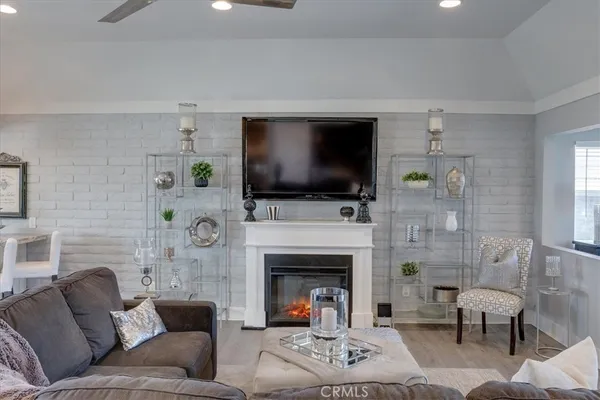 a living room with furniture a flat screen tv and a fireplace