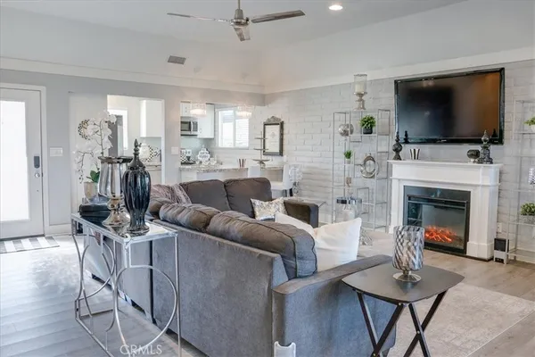 a living room with furniture a fireplace and a flat screen tv
