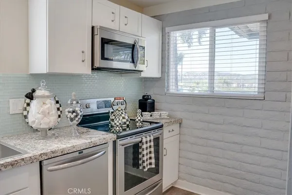 a kitchen with granite countertop a sink and a window