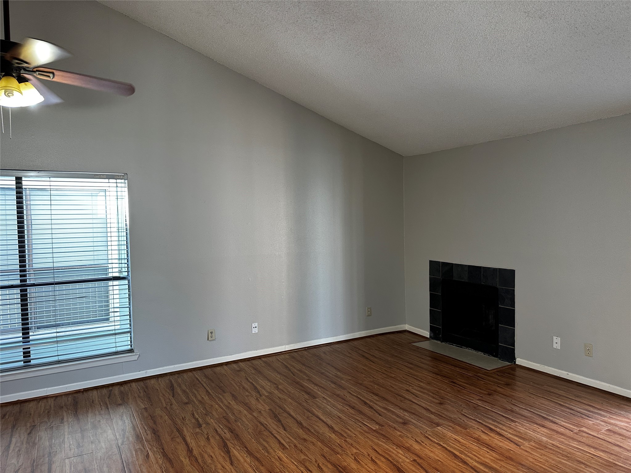 3756 Tanglewilde Street, Unit 8D Houston, TX 77063 - Photo 1 of 14 a view of an empty room with wooden floor and a window