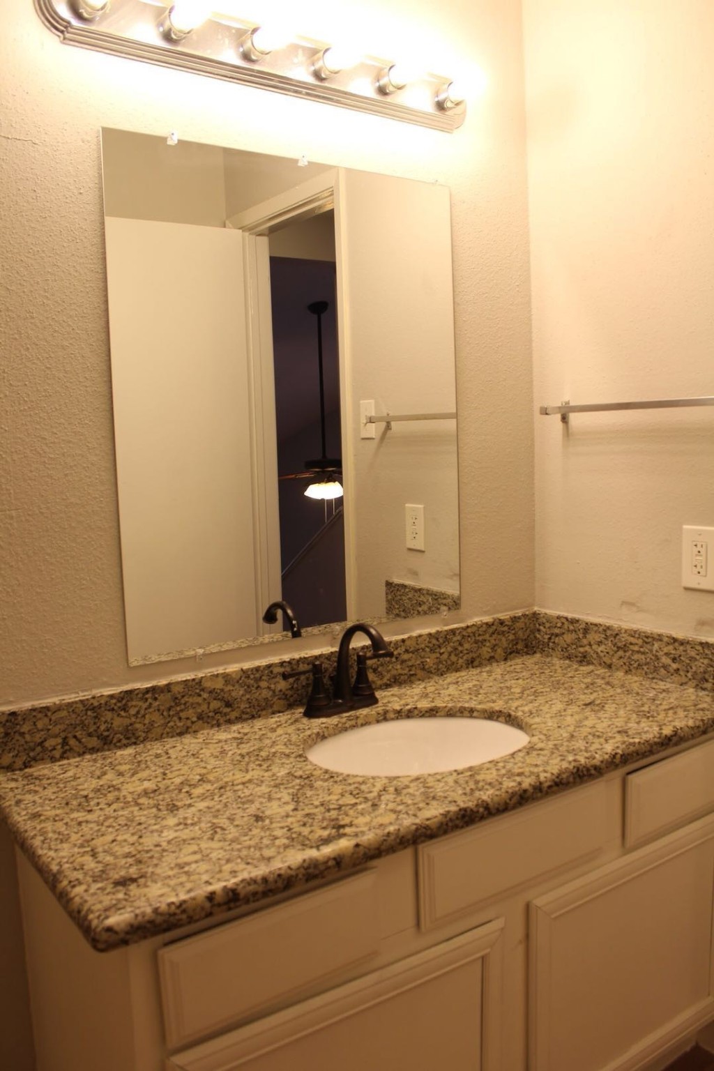 3756 Tanglewilde Street, Unit 8D Houston, TX 77063 - Photo 10 of 14 a bathroom with a granite countertop sink and a mirror