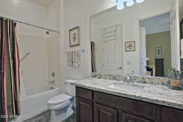 a view of a backyard with wooden fence