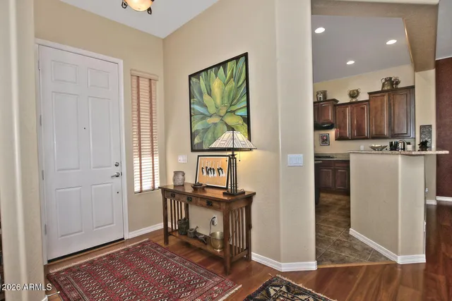 a view of a kitchen with kitchen island stainless steel appliances wooden floor and window