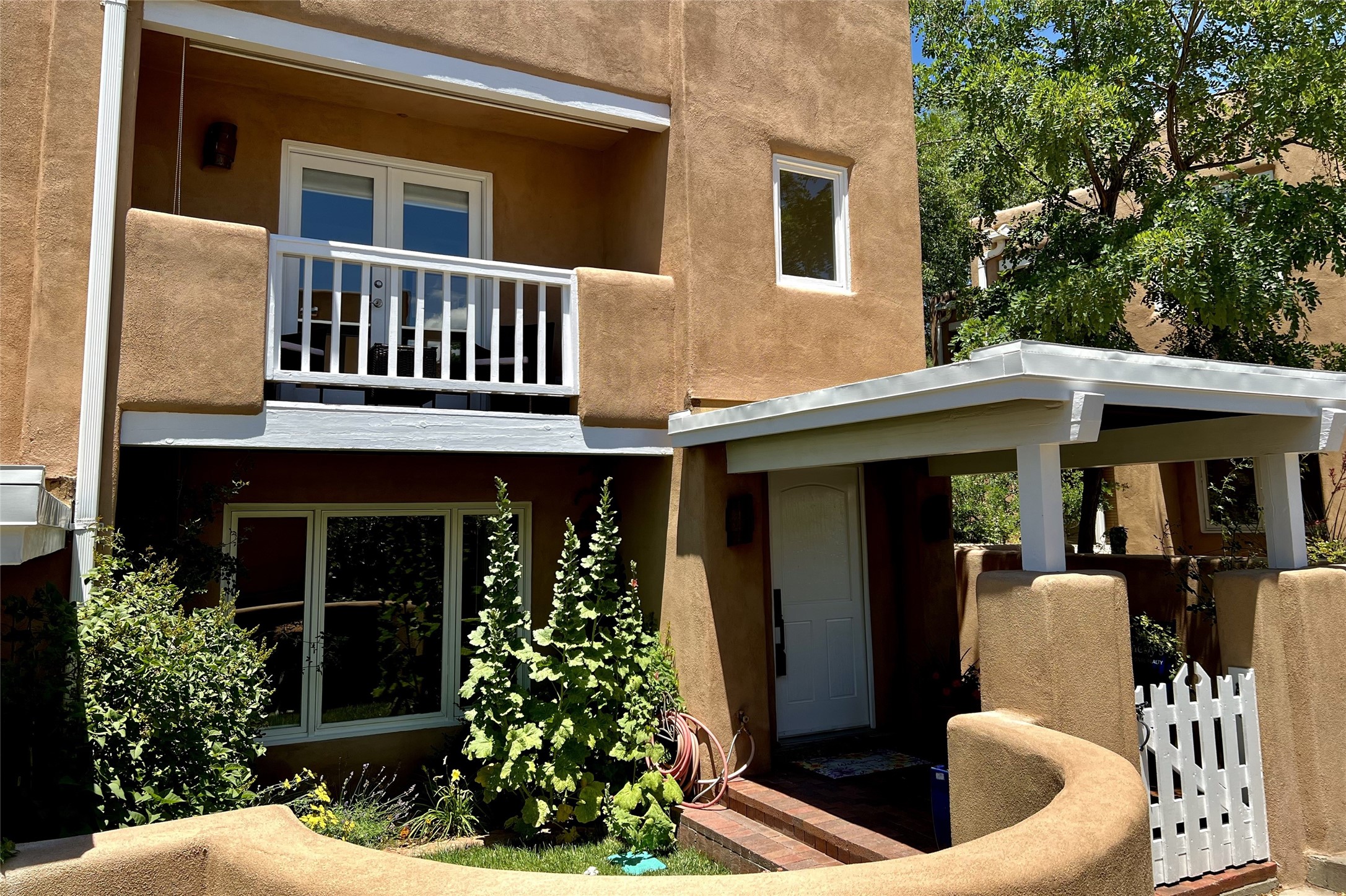 501 Rio Grande Avenue, Unit C1 Santa Fe, NM 87501 - Photo 1 of 1 Covered front entry with landscaped yard