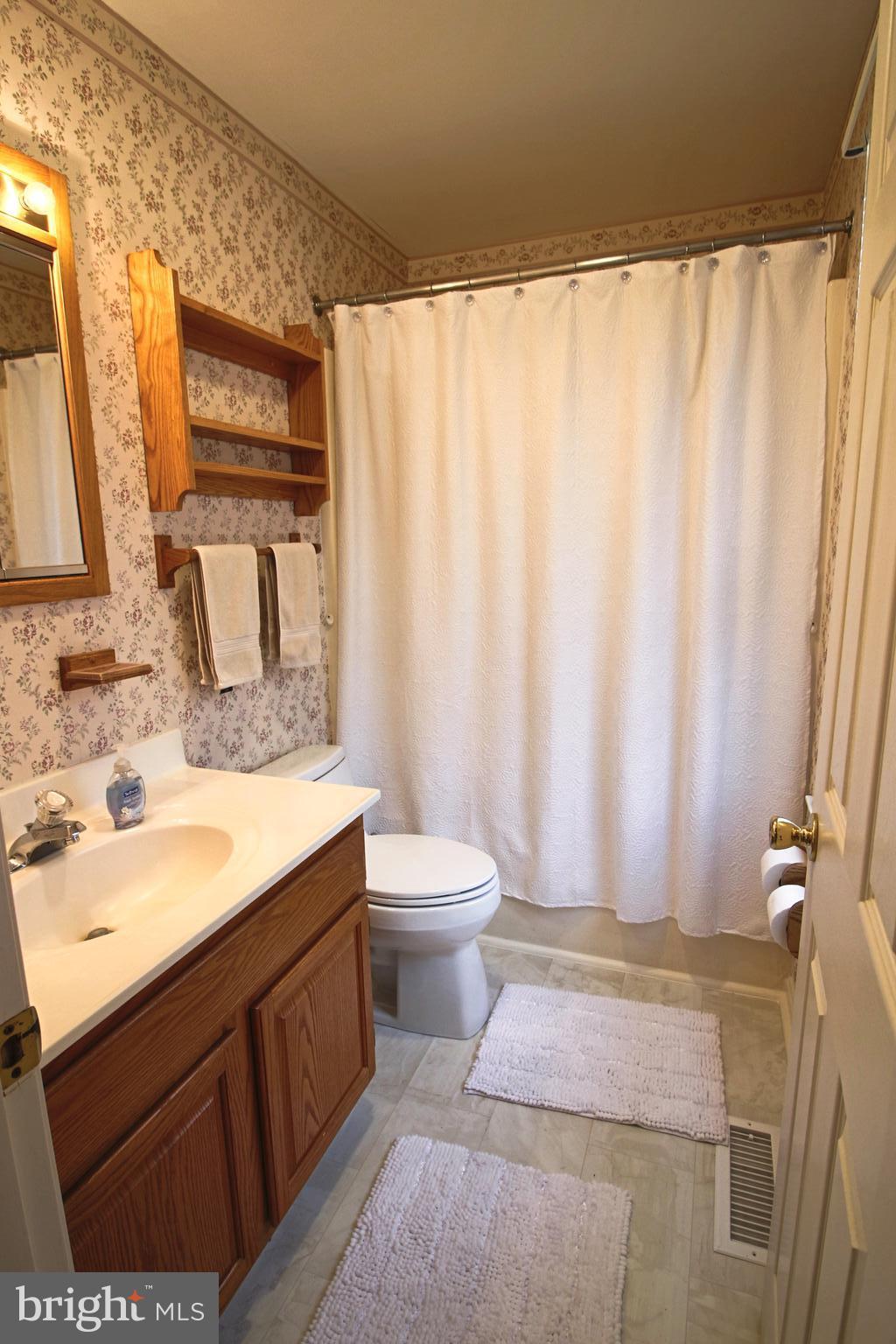 231 Deale Road Tracys Landing, MD 20779 - Photo 17 of 43 a bathroom with a granite countertop sink and a mirror