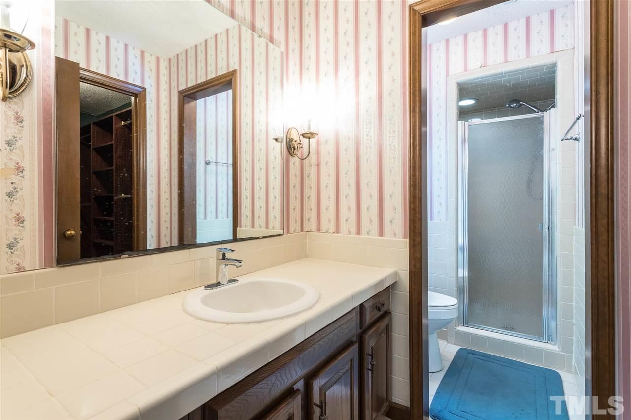 6508 Jade Tree Lane Raleigh, NC 27615 - Photo 22 of 26 a bathroom with a sink and a mirror