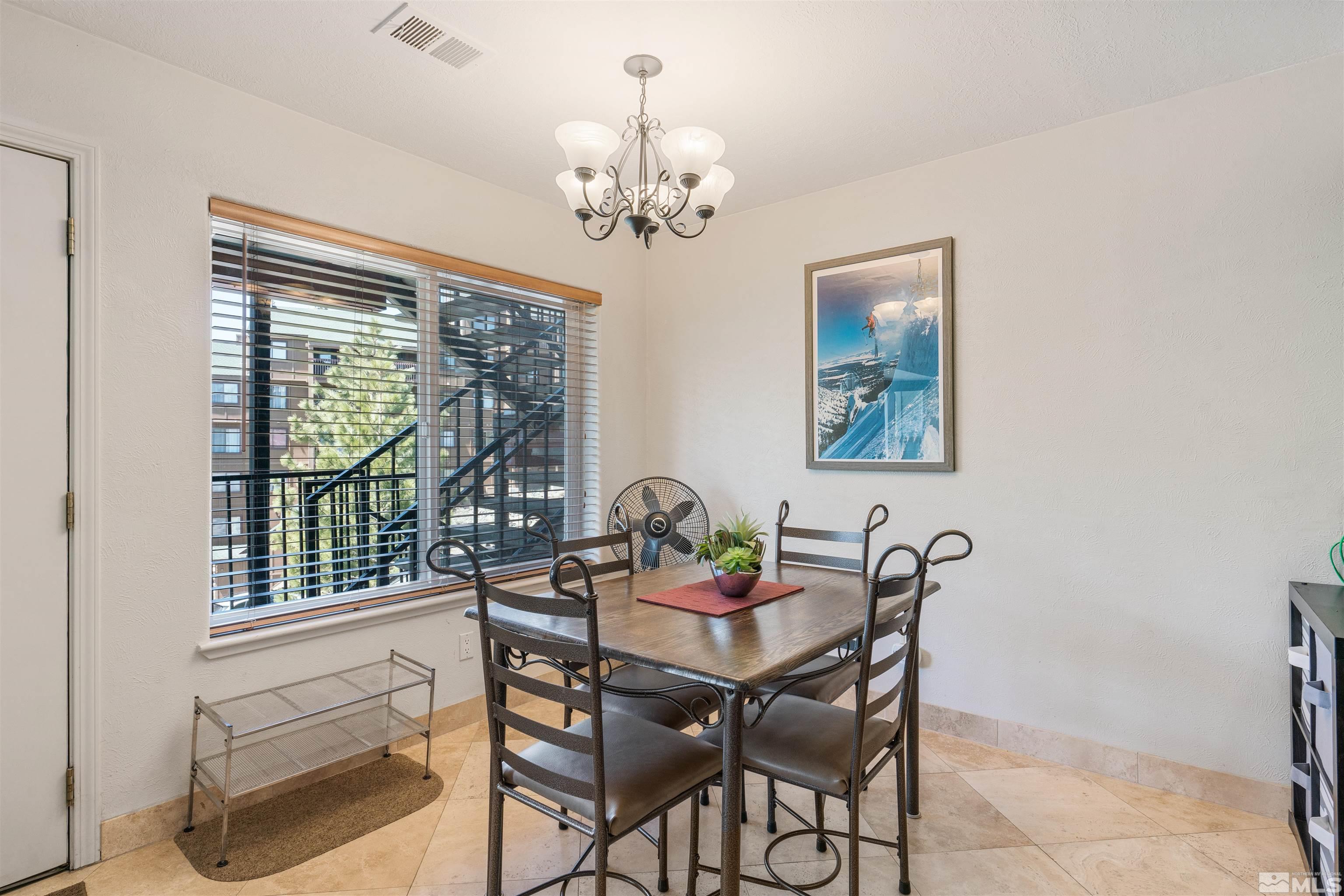 754 Boulder Court, Unit 9 Stateline, NV 89449 - Photo 14 of 38 a dining room with furniture a chandelier and window