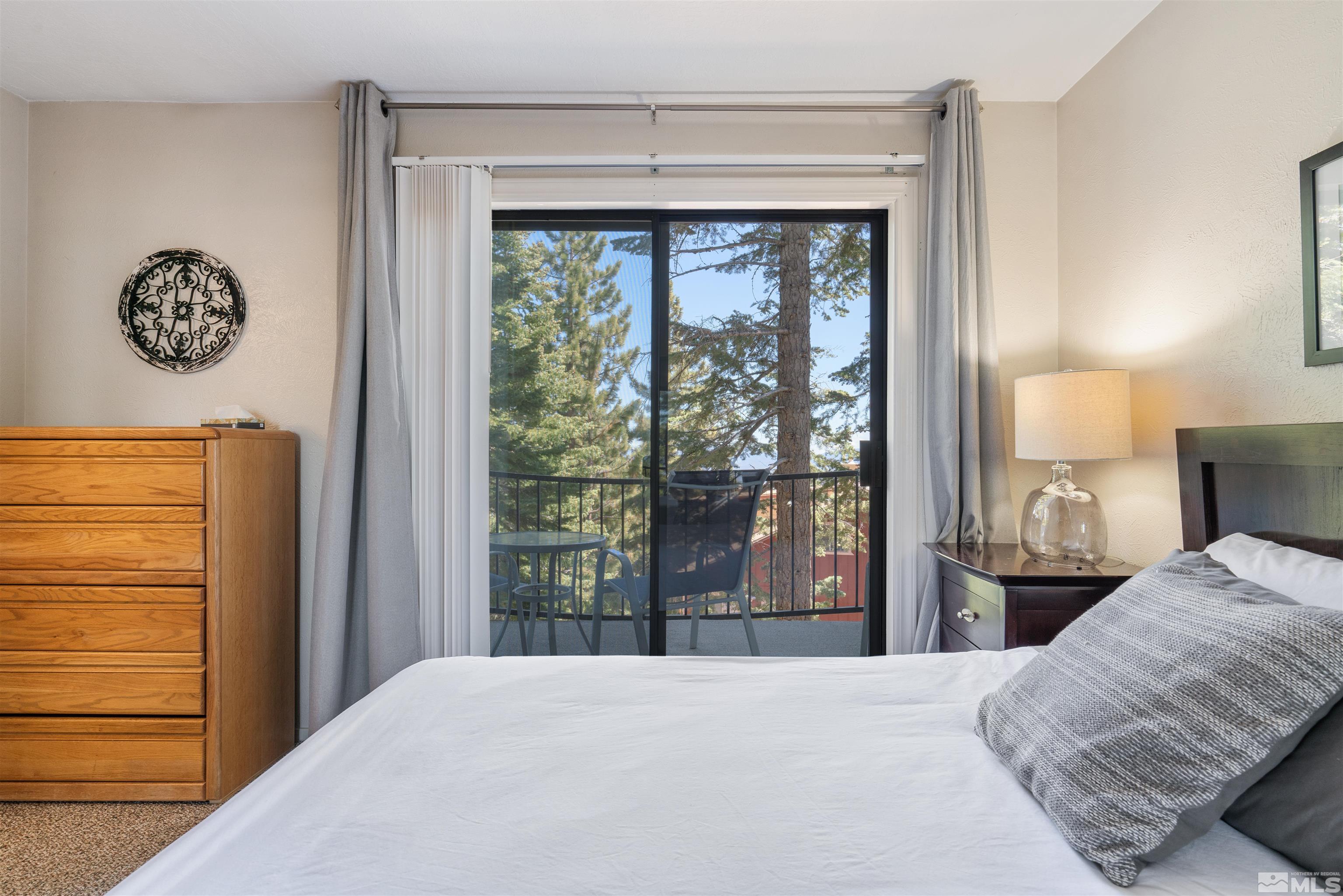 754 Boulder Court, Unit 9 Stateline, NV 89449 - Photo 16 of 38 a bedroom with a bed and a window
