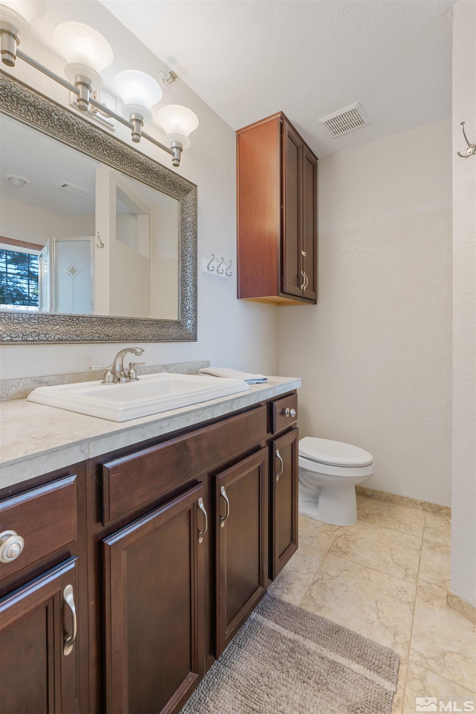 754 Boulder Court, Unit 9 Stateline, NV 89449 - Photo 21 of 38 a bathroom with a sink a toilet and mirror