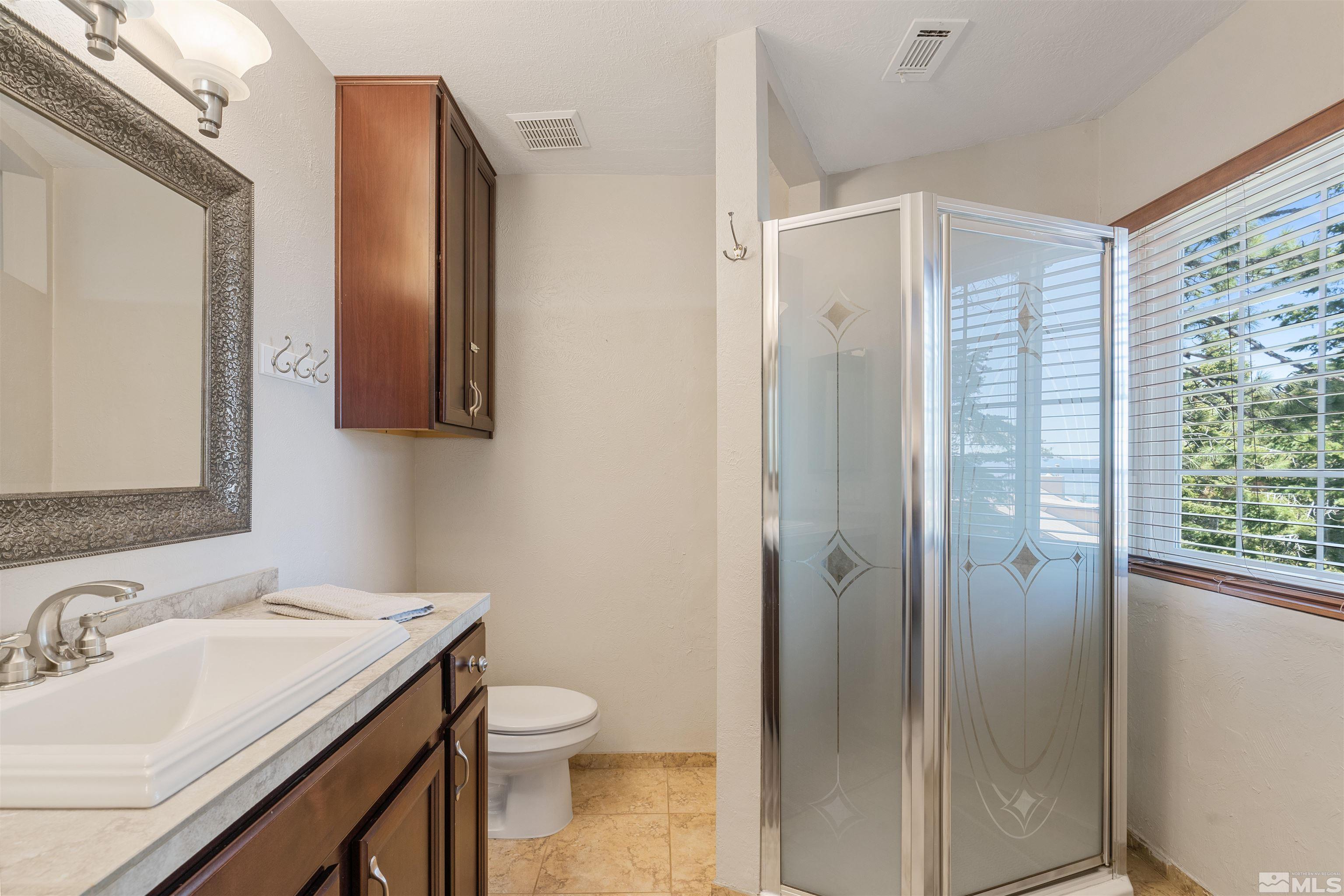 754 Boulder Court, Unit 9 Stateline, NV 89449 - Photo 22 of 38 a bathroom with a granite countertop sink toilet and shower