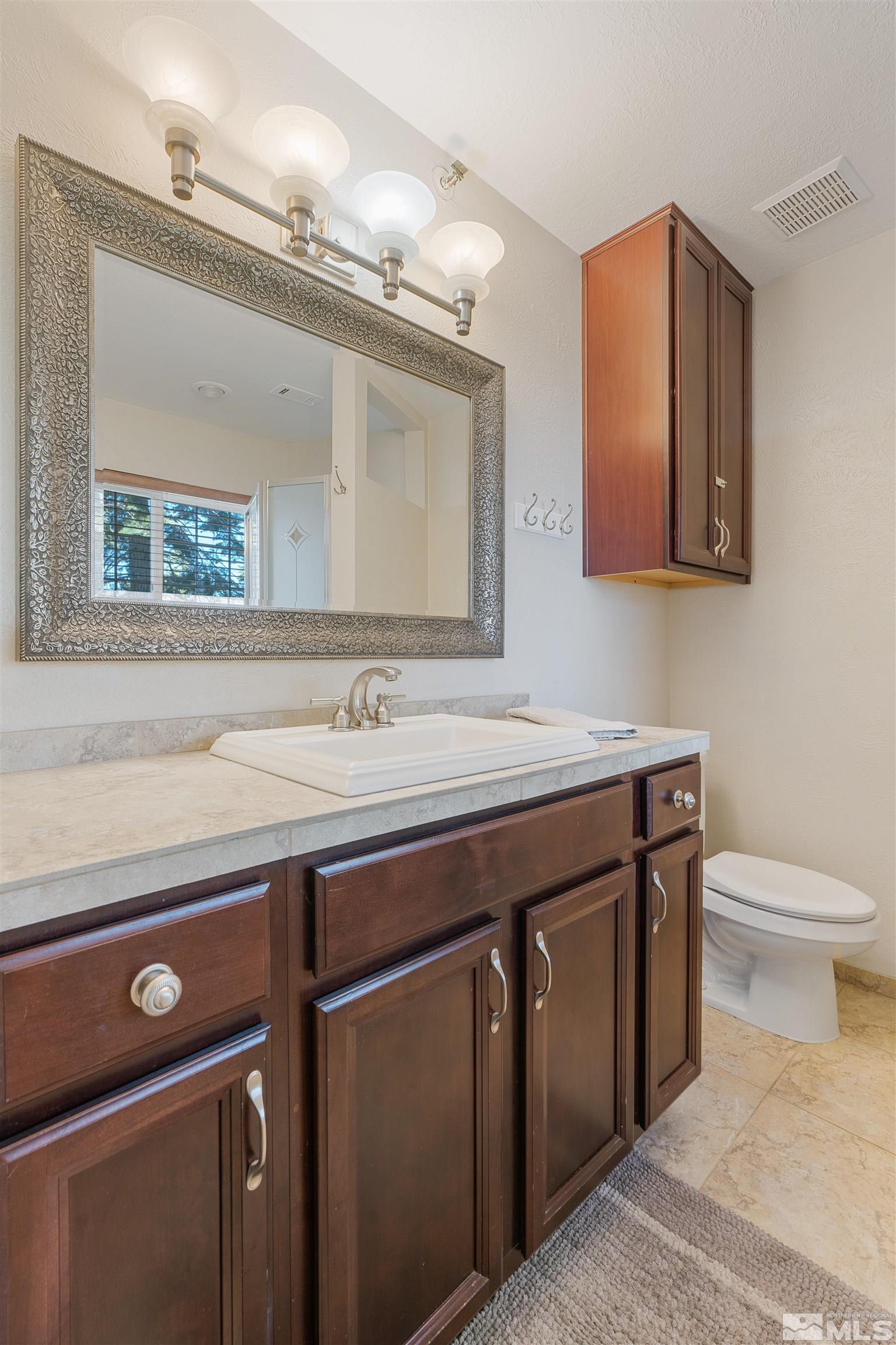 754 Boulder Court, Unit 9 Stateline, NV 89449 - Photo 23 of 38 a bathroom with a granite countertop sink and a mirror