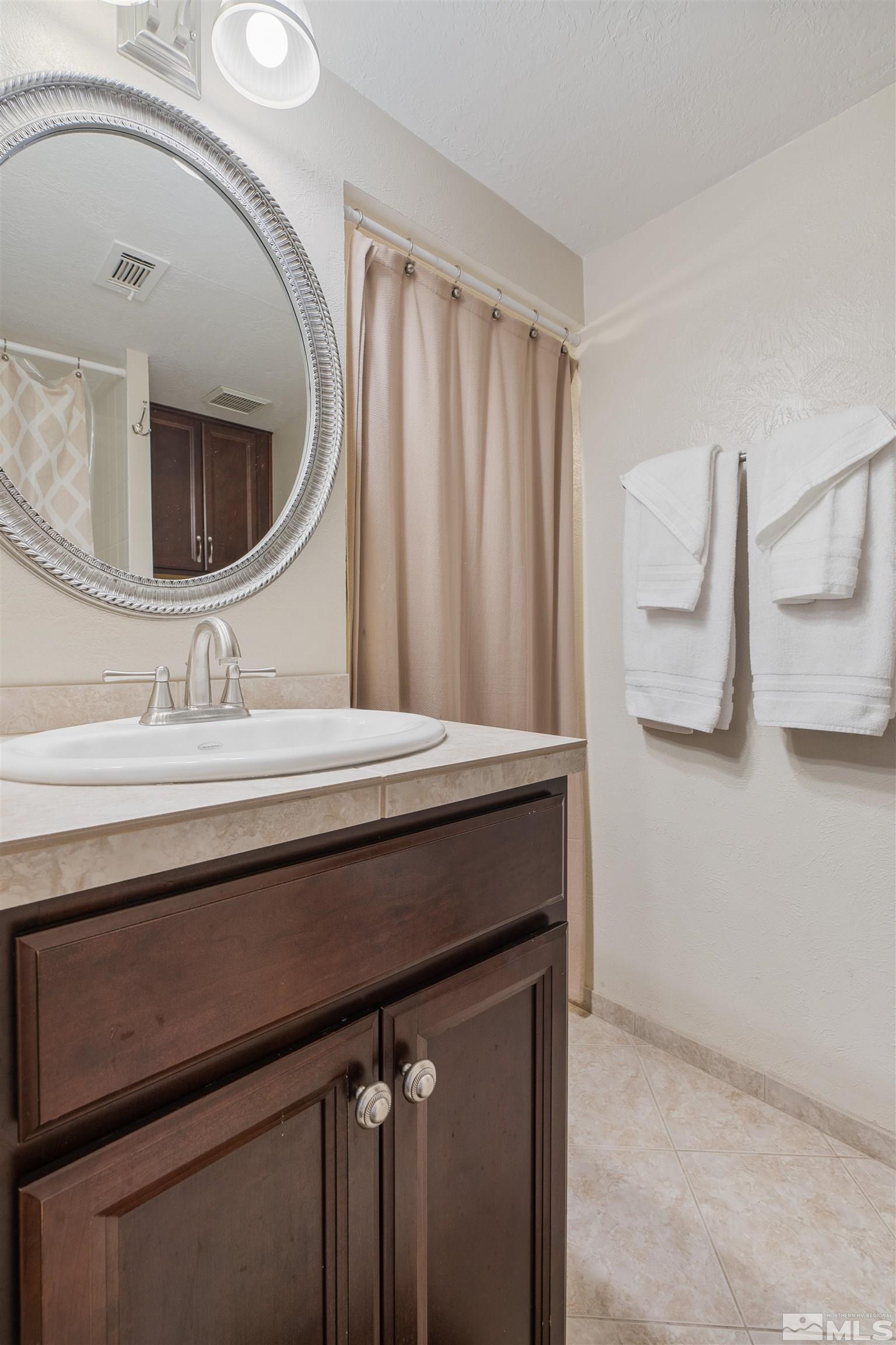 754 Boulder Court, Unit 9 Stateline, NV 89449 - Photo 29 of 38 a bathroom with a sink a vanity and mirror