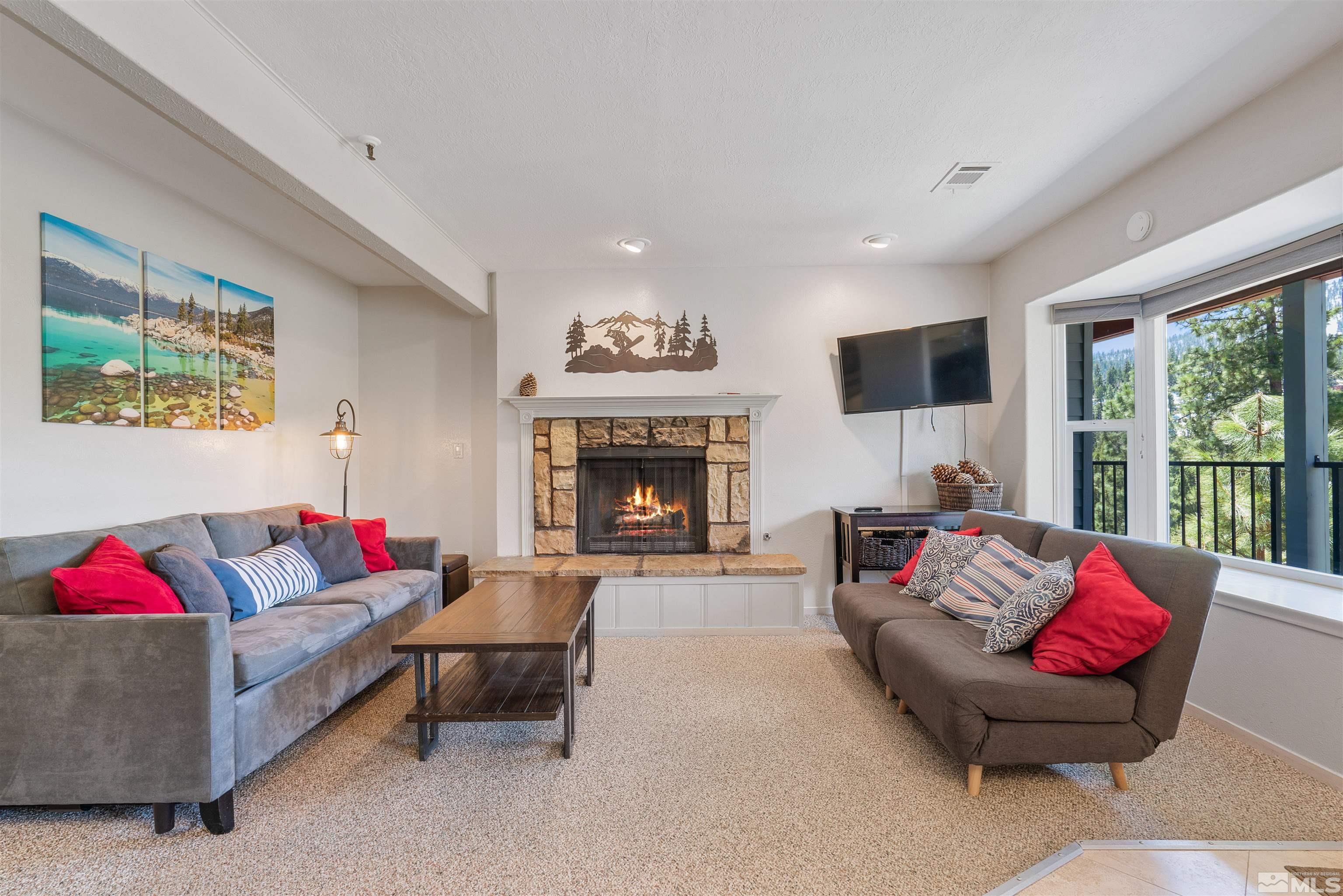754 Boulder Court, Unit 9 Stateline, NV 89449 - Photo 3 of 38 a living room with furniture fireplace and a large window