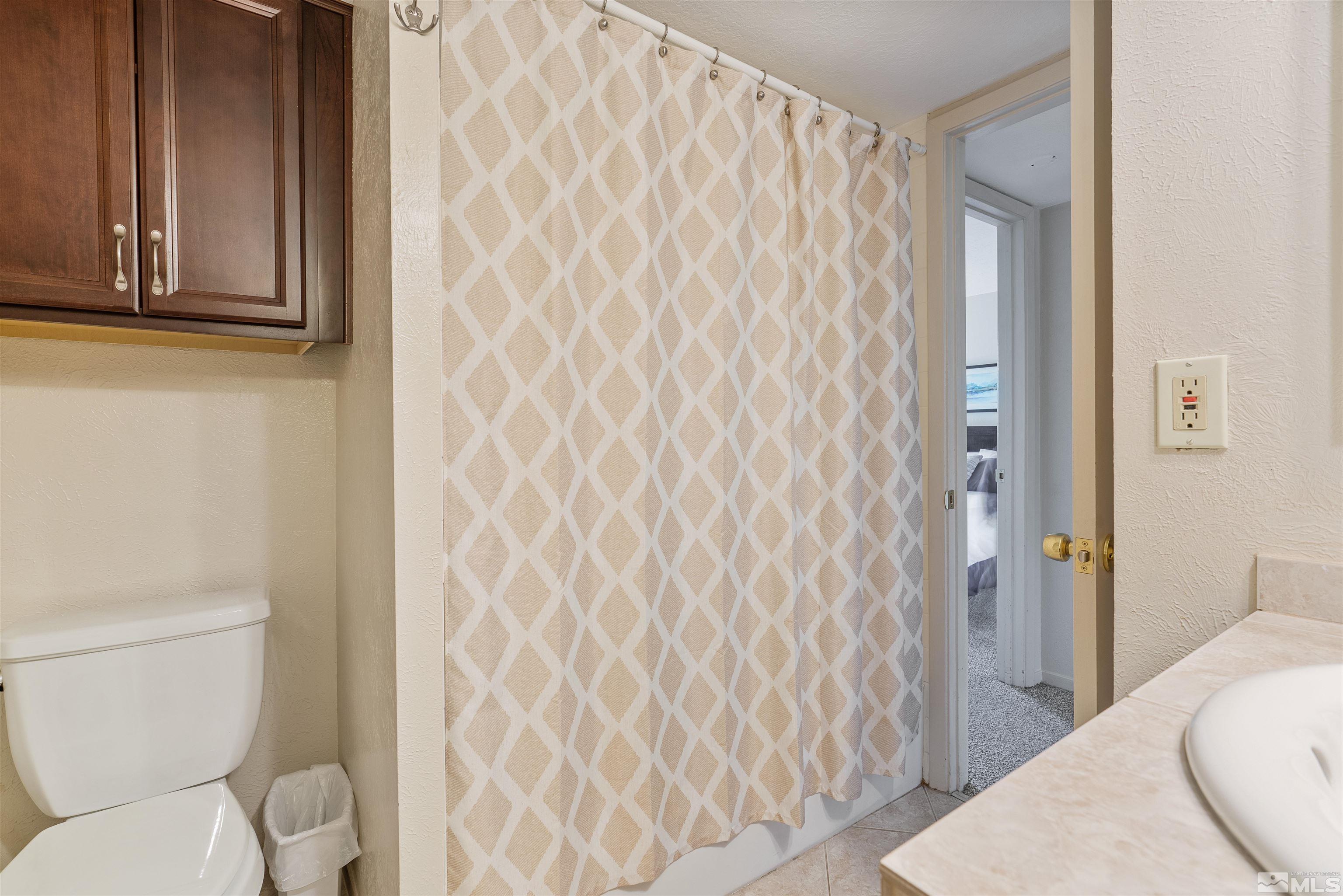 754 Boulder Court, Unit 9 Stateline, NV 89449 - Photo 31 of 38 a bathroom with a toilet and a shower curtain