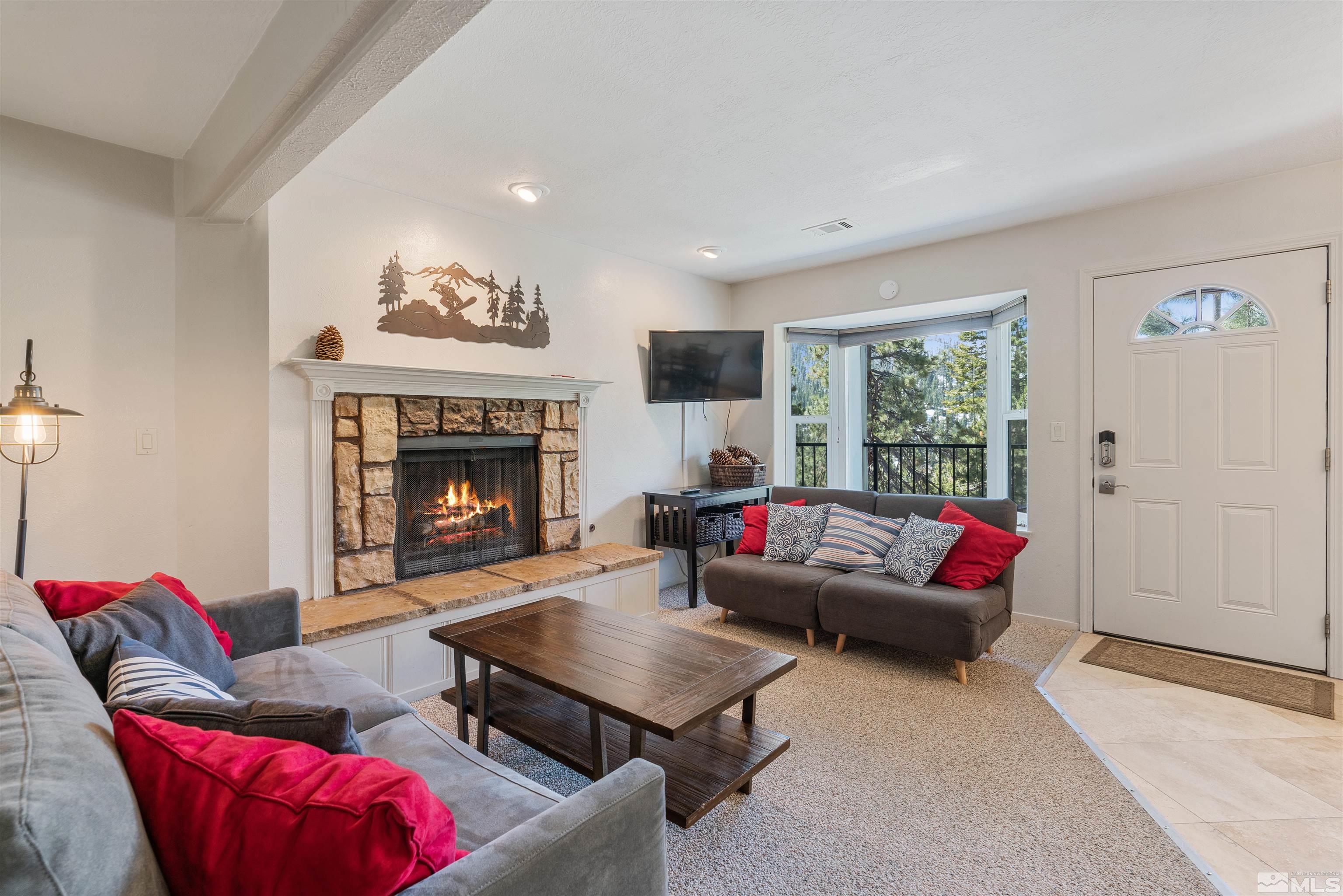 754 Boulder Court, Unit 9 Stateline, NV 89449 - Photo 6 of 38 a living room with furniture a flat screen tv and a fireplace
