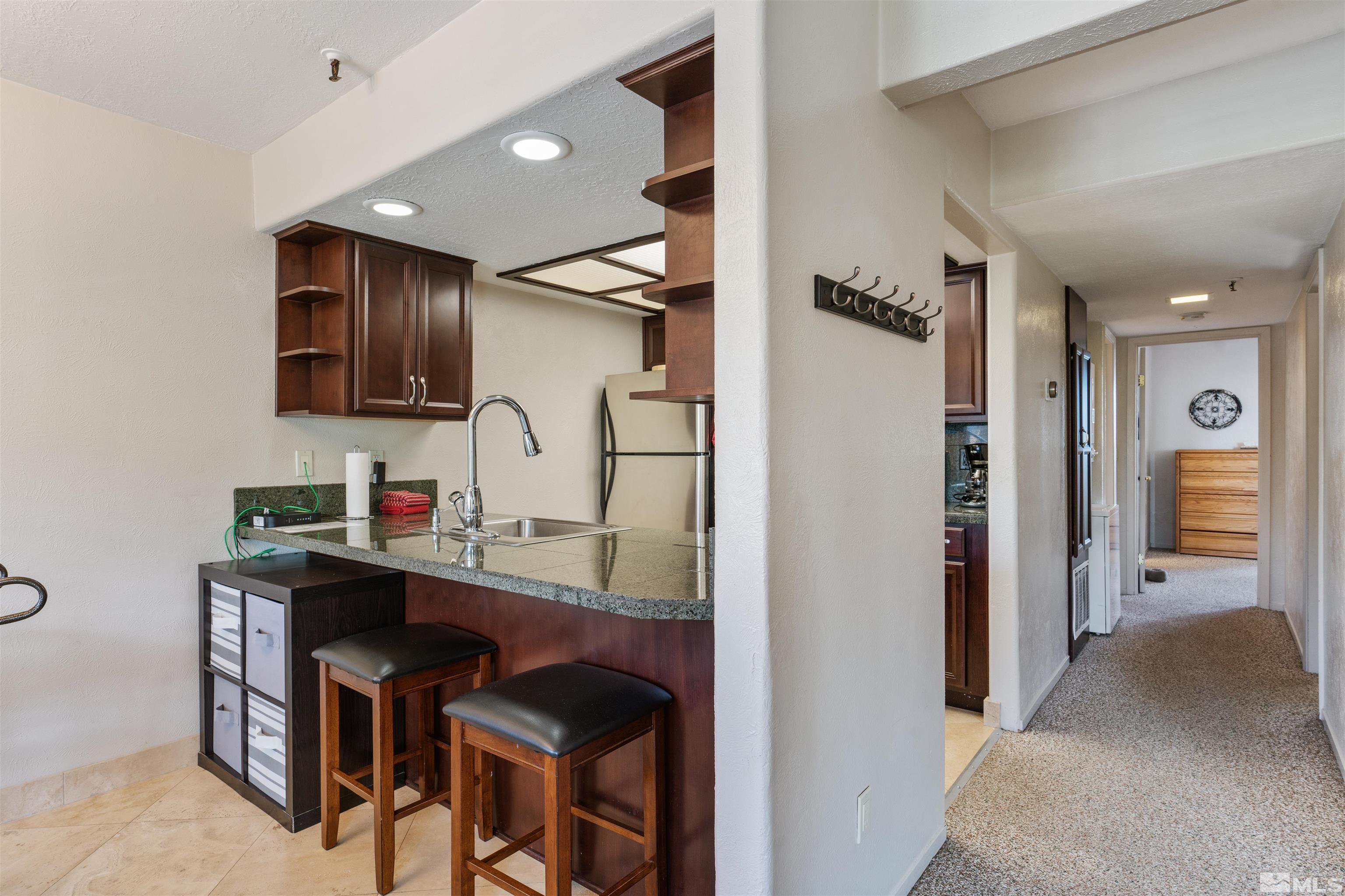 754 Boulder Court, Unit 9 Stateline, NV 89449 - Photo 8 of 38 a kitchen with stainless steel appliances granite countertop a refrigerator and a sink