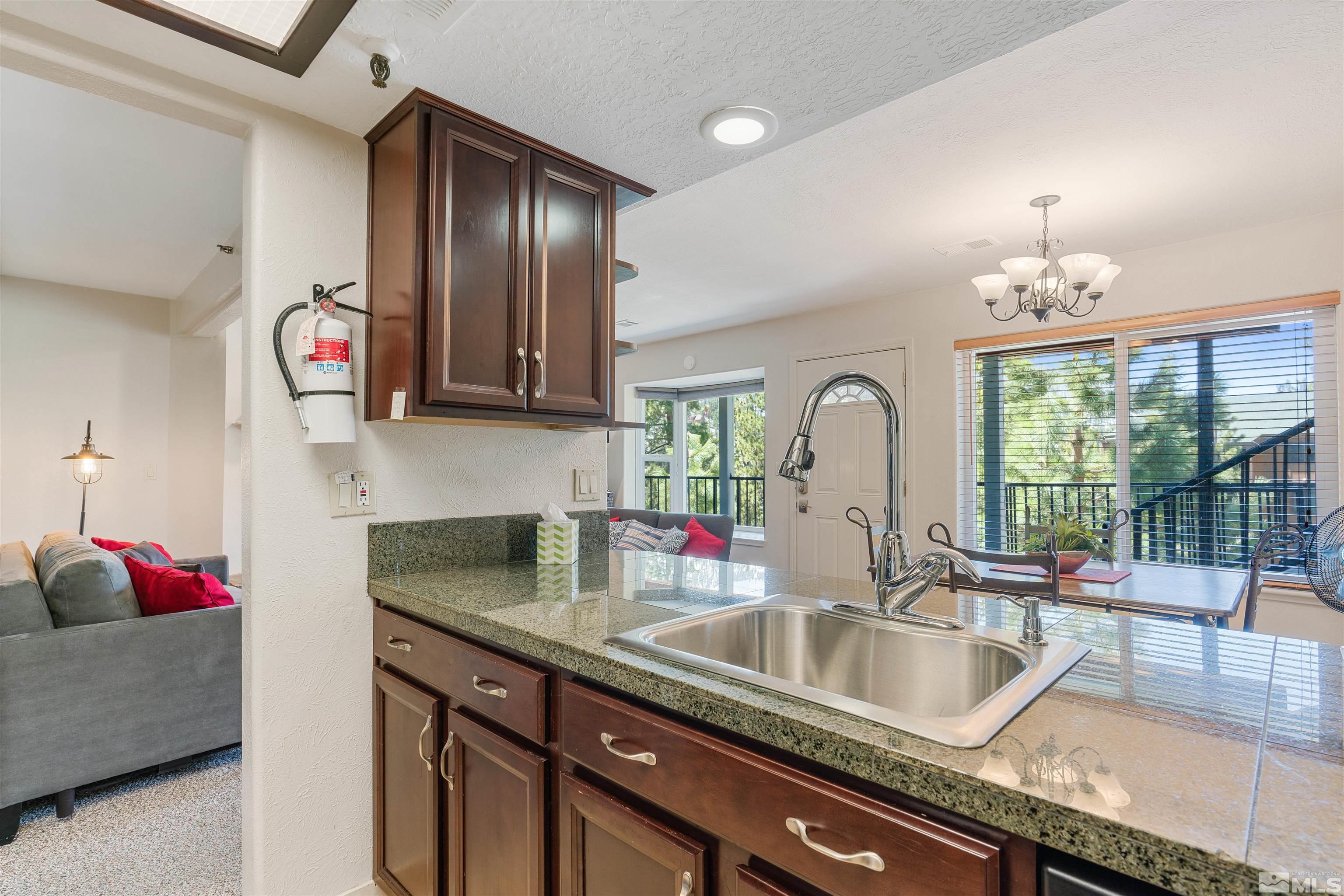 754 Boulder Court, Unit 9 Stateline, NV 89449 - Photo 10 of 38 a kitchen with granite countertop a sink and a large window