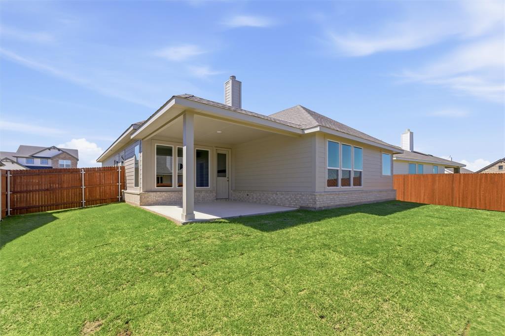 1225 Sabine River Lane Springtown, TX 76082 - Photo 21 of 25 Back of house featuring a fenced backyard, a patio, brick siding, and a chimney