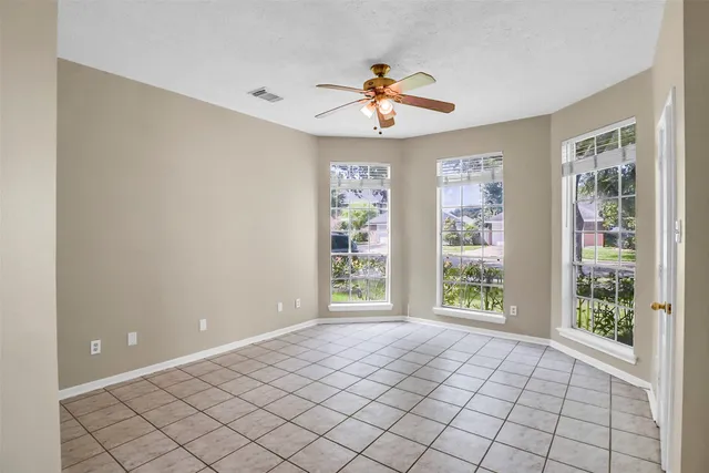 a spacious bathroom with a granite countertop sink a mirror and a bathtub