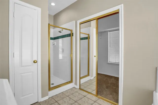 a view of a hallway with closet and wooden floor