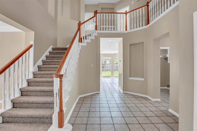 a front view of a house with a garden and yard
