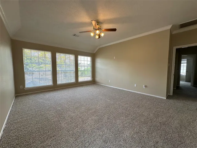 front view of a brick house with a yard