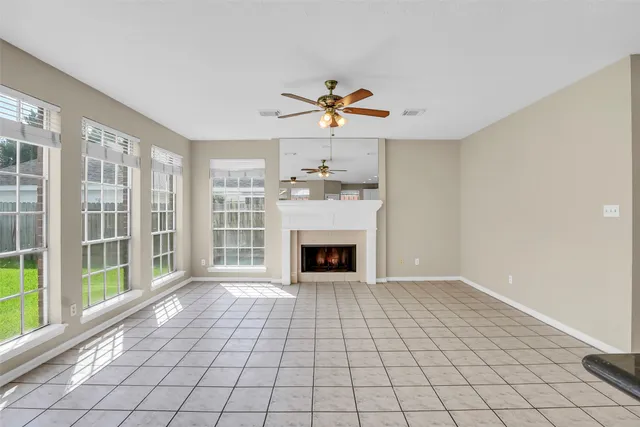 a view of a livingroom with a fireplace and window