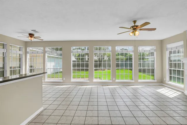 a view of staircase with lots of frames on wall and a window
