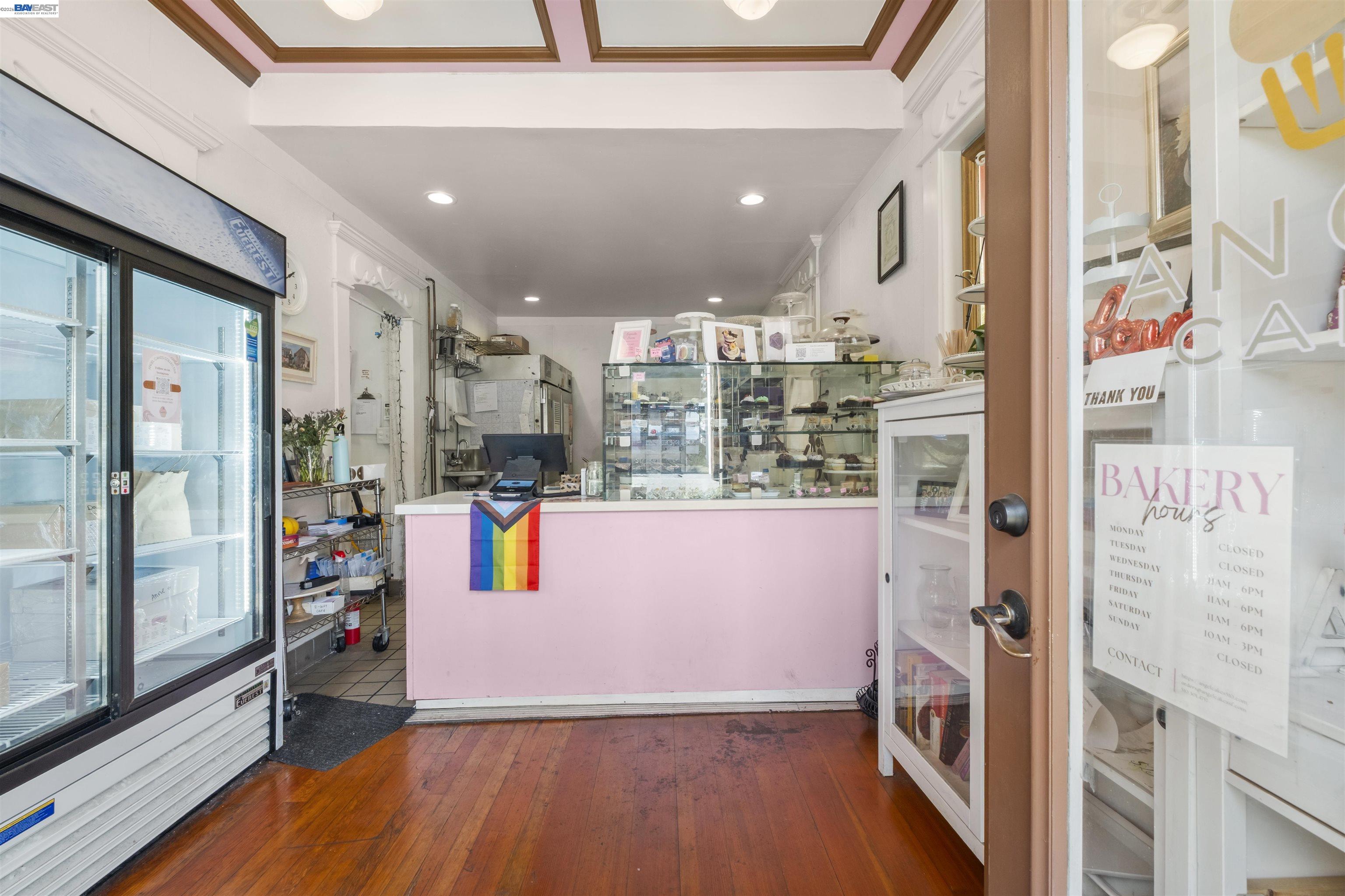 745 Fifth Street Oakland, CA 94607 - Photo 5 of 26 a view of open kitchen with stainless steel appliances refrigerator and wooden floor